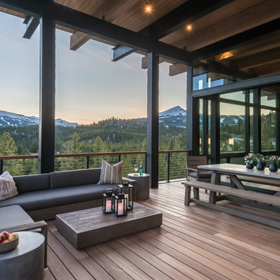 Large trendy cable railing balcony photo in Other with a roof extension