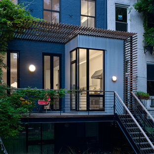 Inspiration for a mid-sized contemporary mixed material railing balcony remodel in New York with a pergola