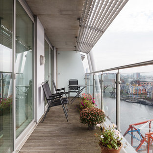 This is an example of a contemporary mixed railing balcony in Manchester with an awning.
