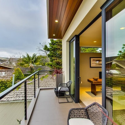 Inspiration for a small contemporary balcony remodel in San Diego with a roof extension