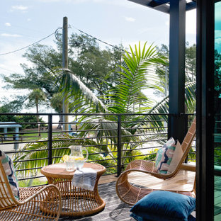 Mid-sized minimalist metal railing balcony photo in Tampa with a roof extension