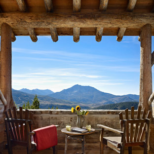 Balcony - rustic balcony idea in Other with a roof extension