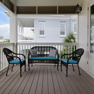 Inspiration for a mid-sized coastal balcony remodel in Miami with a roof extension