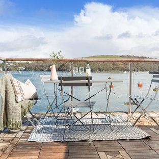 Design ideas for a small nautical glass railing balcony in Cornwall with no cover.