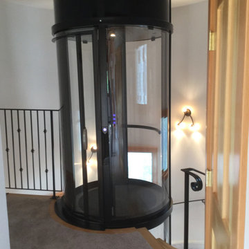 Round Acrylic Home Elevator Incorporated into Staircase