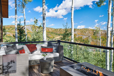 Large mountain style glass railing balcony photo in Denver with a fire pit and no cover