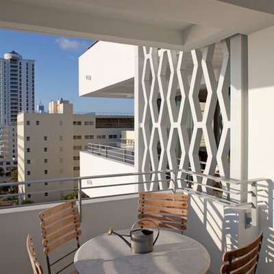 Balcony - contemporary apartment balcony idea in Miami with a roof extension