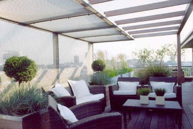 Inspiration for a large contemporary balcony in Surrey with a pergola.