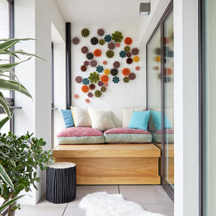 Inspiration for a medium sized contemporary balcony in London with a roof extension.