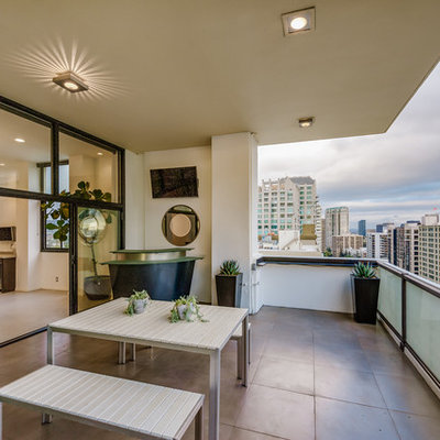 Inspiration for a huge contemporary mixed material railing balcony remodel in Los Angeles with a roof extension