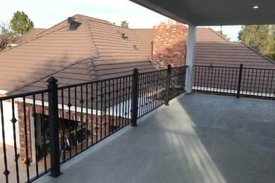 Inspiration for a classic metal railing balcony in Phoenix with a roof extension.