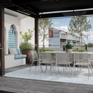 Mid-sized contemporary balcony in Sydney with an awning and metal railing.