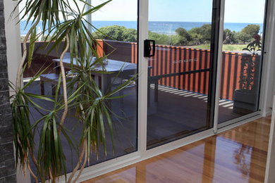 Medium sized contemporary balcony in Sydney with an awning.