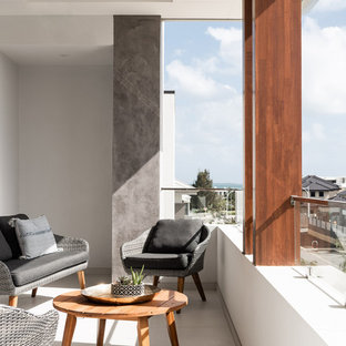 Photo of a contemporary balcony in Perth with a roof extension and mixed railing.
