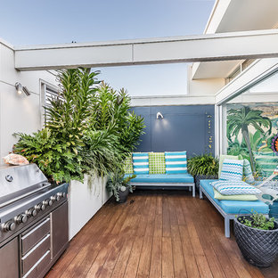 Design ideas for a large beach style balcony in Sydney with no cover, metal railing and with privacy feature.