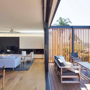 Mid-sized contemporary balcony in Sydney with no cover, glass railing and with privacy feature.