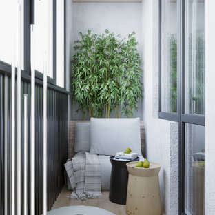 Esempio di un piccolo balcone d'appartamento contemporaneo con parapetto in metallo e un tetto a sbalzo