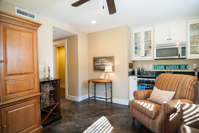 Mid-sized trendy walk-out concrete floor basement photo in Atlanta with beige walls and no fireplace