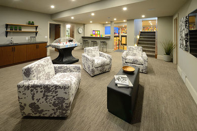 Example of a large trendy underground carpeted and gray floor basement design in Edmonton with gray walls and no fireplace