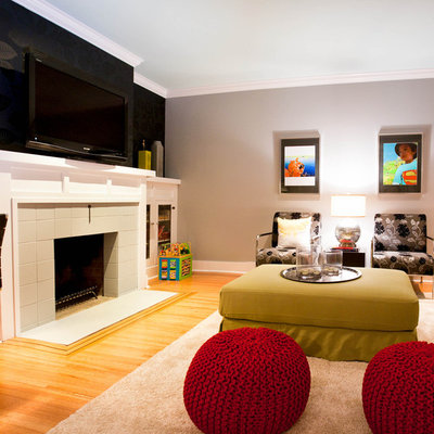 Basement - contemporary underground light wood floor and orange floor basement idea in Vancouver with gray walls, a standard fireplace and a tile fireplace