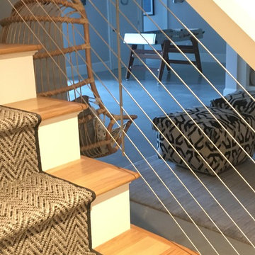 A stair railing accented with nautical wire roping.