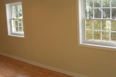 Inspiration for a large light wood floor basement remodel in Raleigh with yellow walls