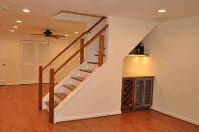 Inspiration for a large transitional walk-out vinyl floor and brown floor basement remodel in DC Metro with white walls