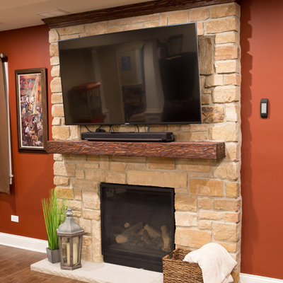 Basement - large traditional underground dark wood floor and brown floor basement idea in Chicago with beige walls, a standard fireplace and a stone fireplace