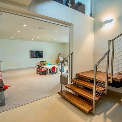 Trendy look-out carpeted and beige floor basement photo in Los Angeles with white walls and no fireplace
