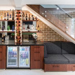 Design ideas for a contemporary basement in Sydney with brown walls, grey floor and brick walls.