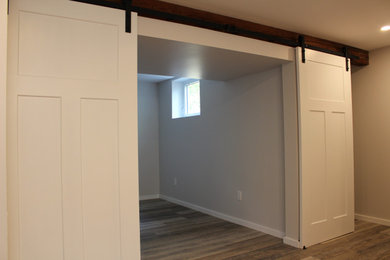 Example of an arts and crafts basement design in Other