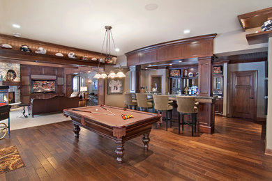 Design ideas for a traditional games room in Minneapolis with brown walls, dark hardwood flooring, a corner fireplace, a stone fireplace surround and brown floors.