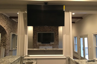 Example of a large basement design in Atlanta with a stone fireplace