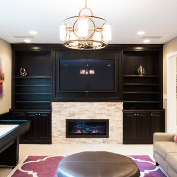 Basement Family Room with Stone Fireplace, Built-In Bookshelves, and a Game Tabl