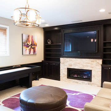 Basement Family Room with Stone Fireplace, Built-In Bookshelves, and Game Table