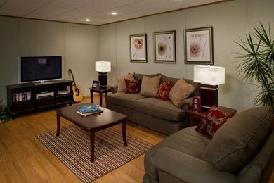 Inspiration for a mid-sized timeless medium tone wood floor basement remodel in Boston with beige walls