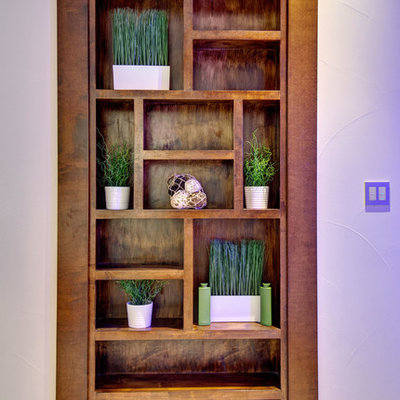 Example of a large trendy look-out carpeted and white floor basement design in Denver with white walls and no fireplace