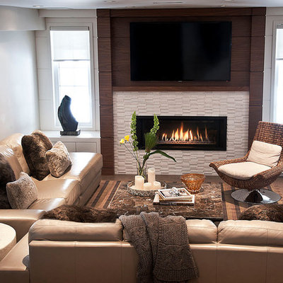 Example of a trendy walk-out porcelain tile basement design in Toronto with beige walls, a ribbon fireplace and a tile fireplace
