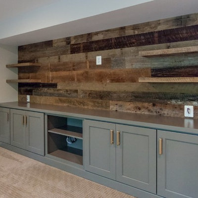 Inspiration for a timeless walk-out carpeted and beige floor basement remodel in DC Metro with beige walls, a standard fireplace and a brick fireplace