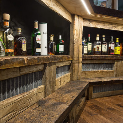 Large mountain style walk-out dark wood floor basement photo in Other with white walls and a standard fireplace
