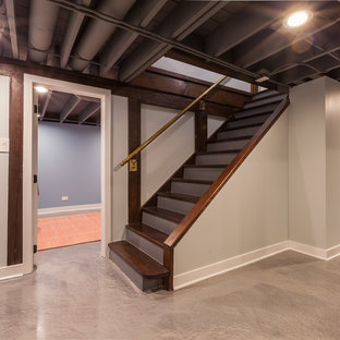 Inspiration pour un sous-sol minimaliste semi-enterré et de taille moyenne avec un mur gris, béton au sol, aucune cheminée et un sol bleu.