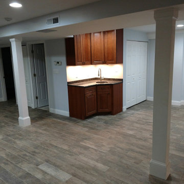 Basement remodel with hidden audio theater area and wet bar