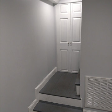 Basement remodel with hidden audio theater area and wet bar
