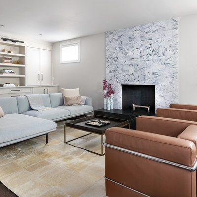 Example of a mid-sized trendy walk-out dark wood floor and brown floor basement design in DC Metro with white walls, a standard fireplace and a brick fireplace