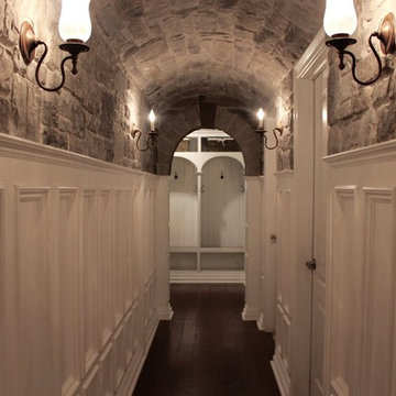 Basement renovation with stone arched hallway