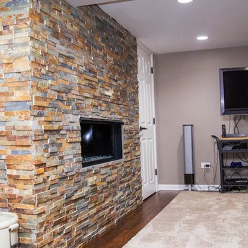 Basement with Stone Fireplace and Half Bathroom