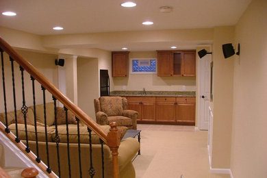This is an example of a large traditional look-out basement in Cincinnati with beige walls and carpet.