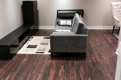 Inspiration for a mid-sized contemporary laminate floor basement remodel in Montreal