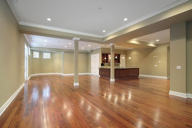 Photo of a medium sized contemporary basement in New York with beige walls and multi-coloured floors.