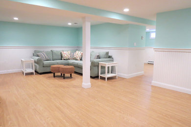 Example of a huge beach style look-out light wood floor basement design in Boston with blue walls and no fireplace